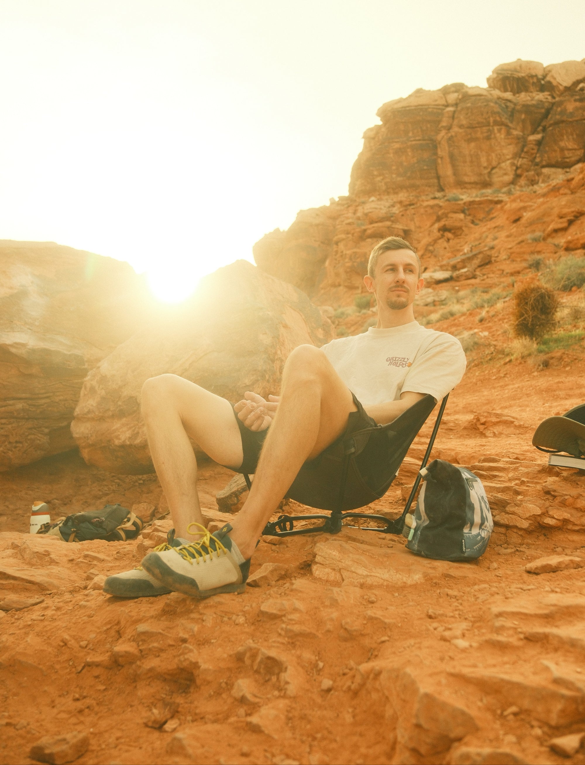 Perons sitting in SDS Chair with Grizzly Holds T-shirt in the desert.